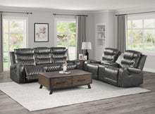 Gray reclining sofa set with a wooden coffee table in a living room.
