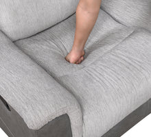 Gray sofa with a person's foot on it, showing the texture and design of the fabric.